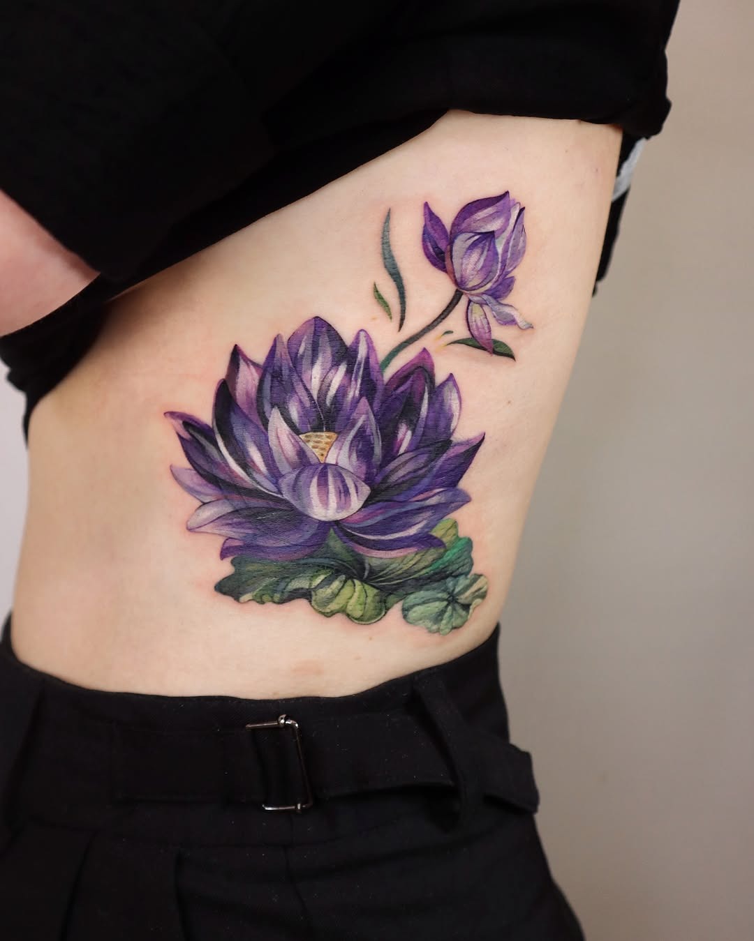 Vibrant watercolor lotus tattoo on the body Tattoo Design