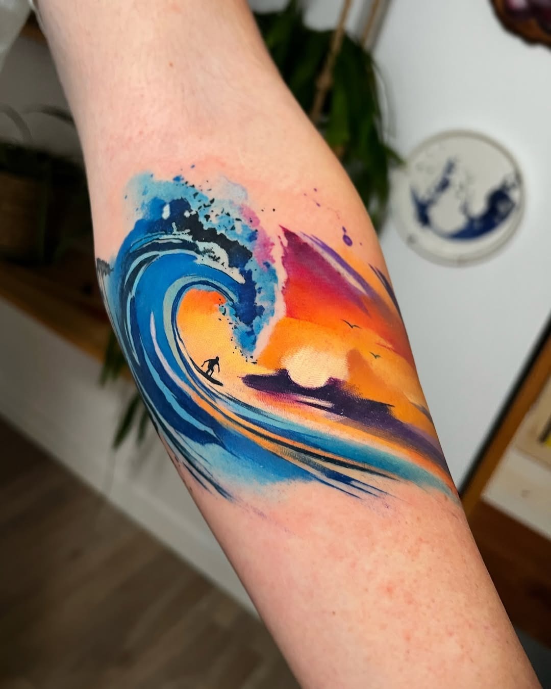 Vibrant wave tattoo with surfer silhouette Tattoo Design