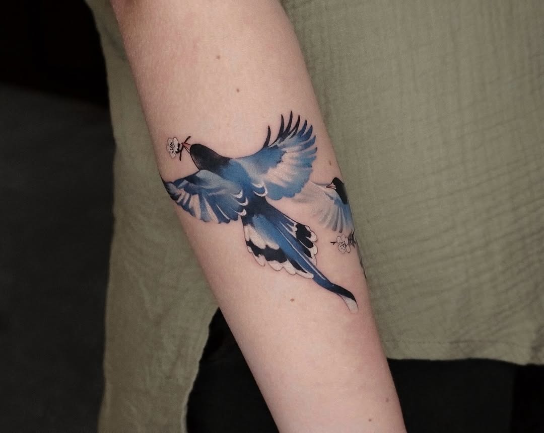 Vivid watercolor bird tattoo in motion Tattoo Design