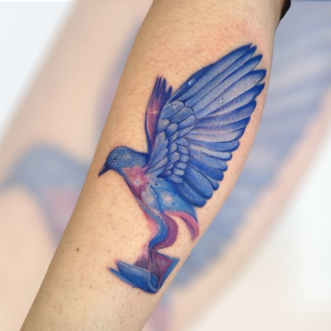 Vivid watercolor bird tattoo showcasing artistic flair Tattoo Design
