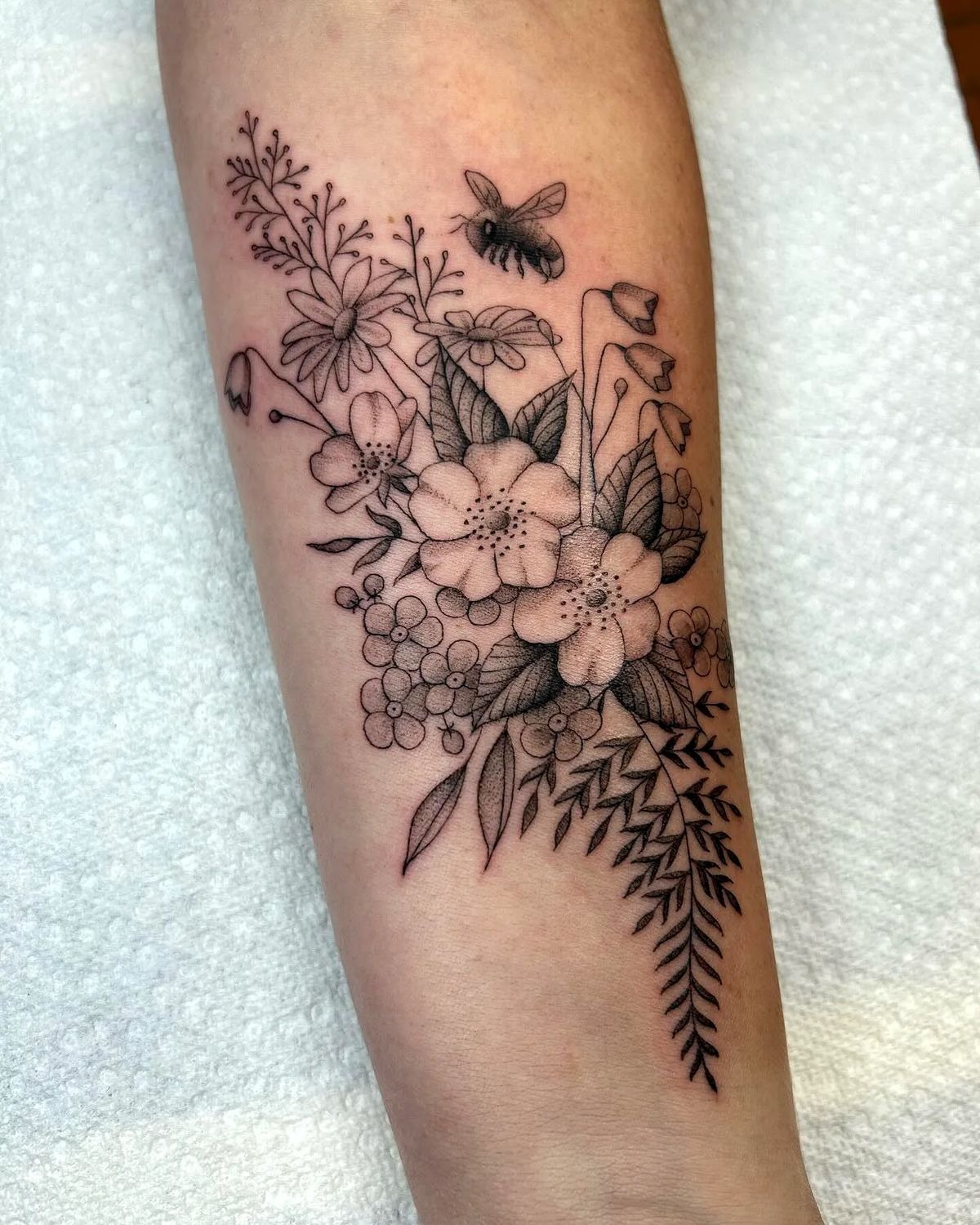 Black and Grey Wildflowers with Bee, a tattoo design rendered in clean detailed linework.