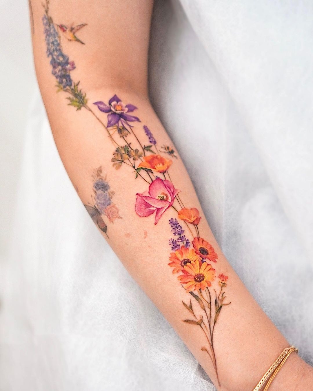Bold Watercolor Wildflower Forearm Tattoo, a tattoo design rendered in watercolor.