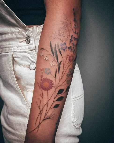 Colorful Wildflower Cascade on the Arm, a tattoo design rendered in clean detailed linework.