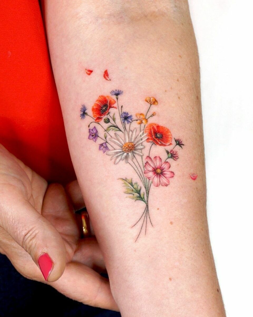 Colorful Wildflower Cluster on the Forearm, a tattoo design rendered in clean detailed linework.