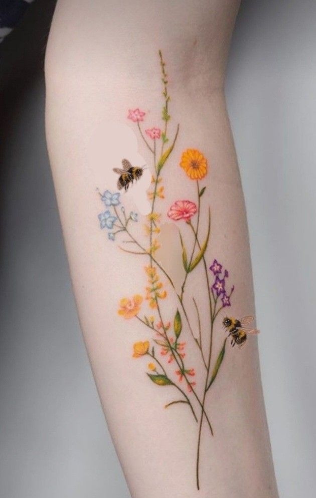 Minimalist Wildflowers with Bees on the Arm, a tattoo design rendered in delicate fine-line for the hand.
