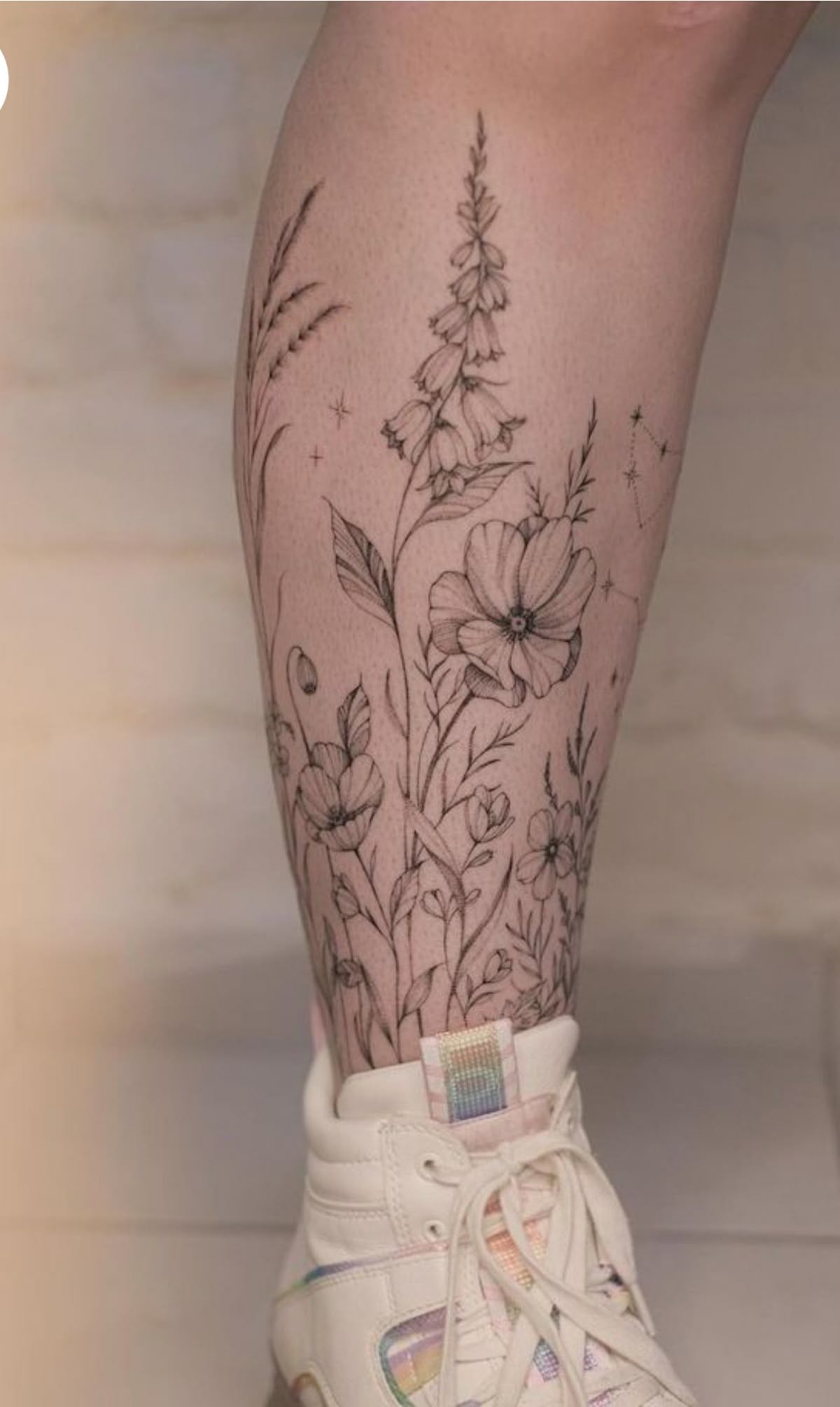 Starlit Leg Wildflowers, a tattoo design rendered in clean detailed linework for the calf.