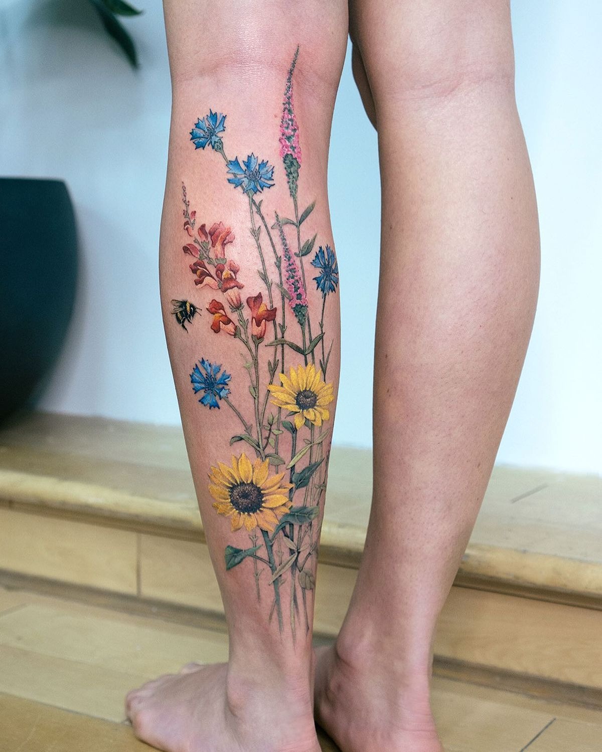 Sunflowers and Cornflowers, a tattoo design rendered in clean detailed linework for the leg.