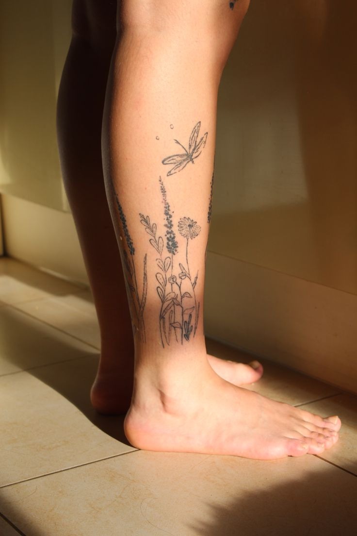 Wildflowers with Dragonfly Accent, a tattoo design rendered in delicate fine-line.