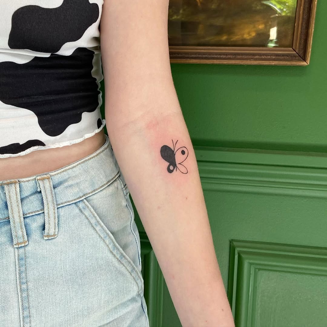Elegant butterfly tattoo with yin yang elements Tattoo Design