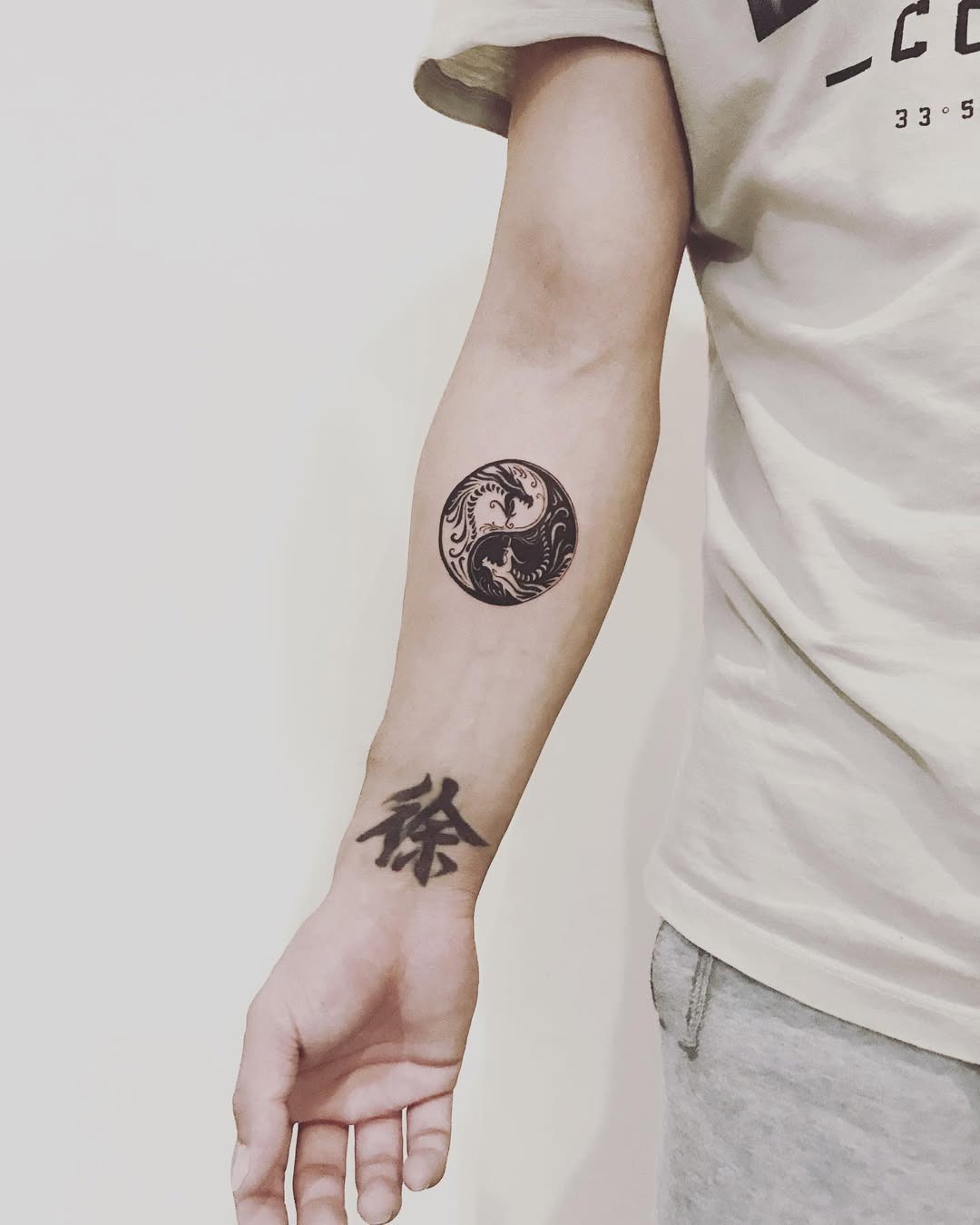 Elegant yin yang tattoo on forearm Tattoo Design