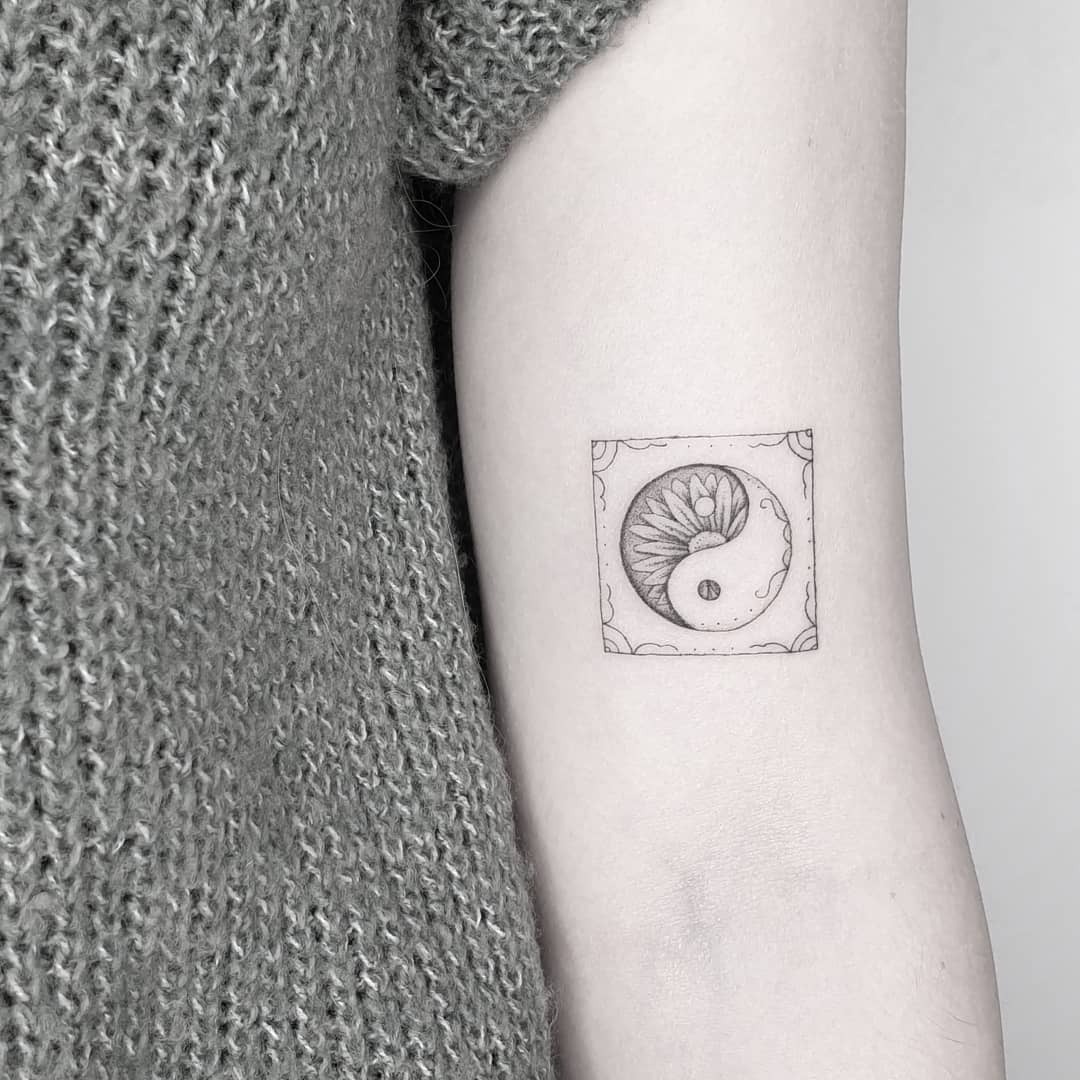 Elegant yin yang tattoo with floral elements Tattoo Design