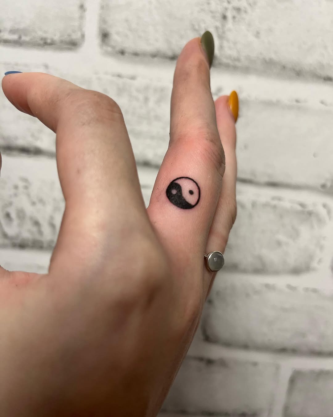 Minimalist yin yang tattoo on a finger Tattoo Design