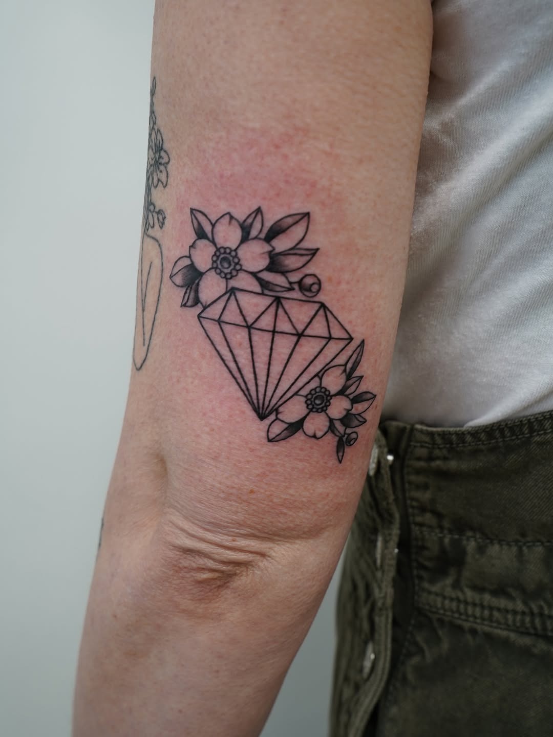Elegant diamond tattoo with floral accents Tattoo Design