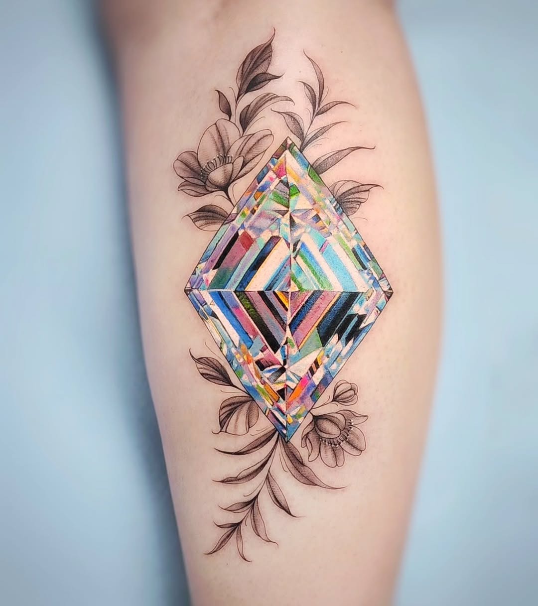 Vibrant diamond tattoo with floral accents Tattoo Design