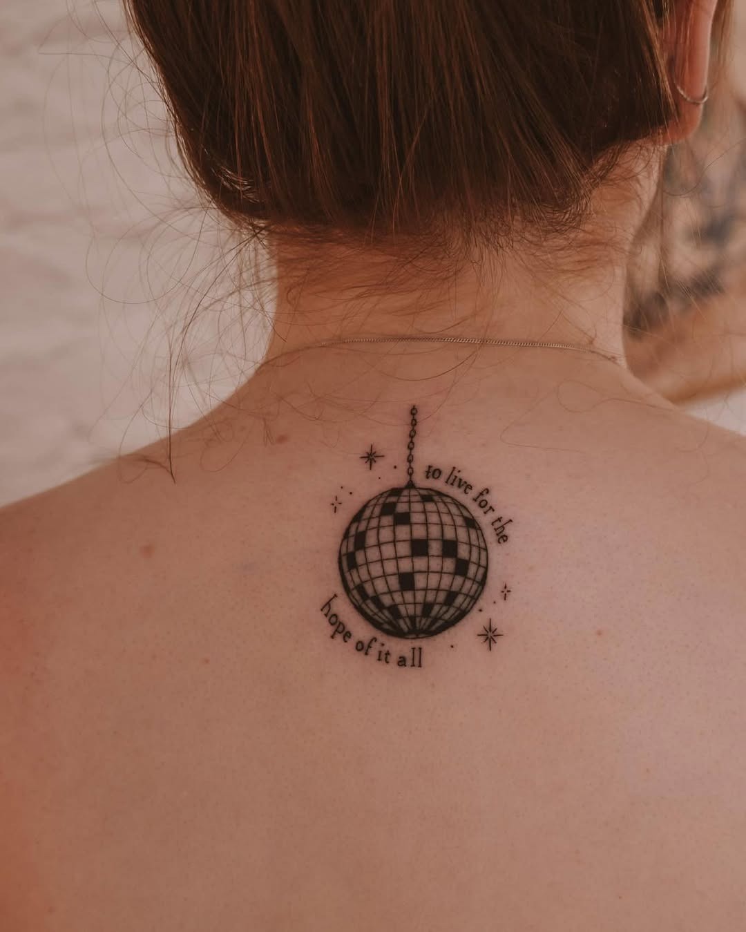 A chic disco ball tattoo with inspiring text Tattoo Design