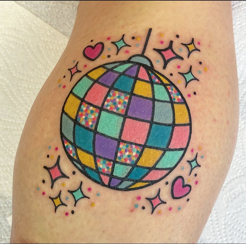 A vibrant disco ball tattoo with playful elements Tattoo Design
