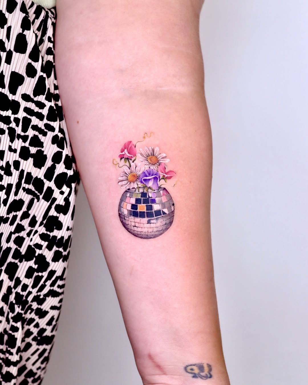 Charming disco ball tattoo with floral details Tattoo Design