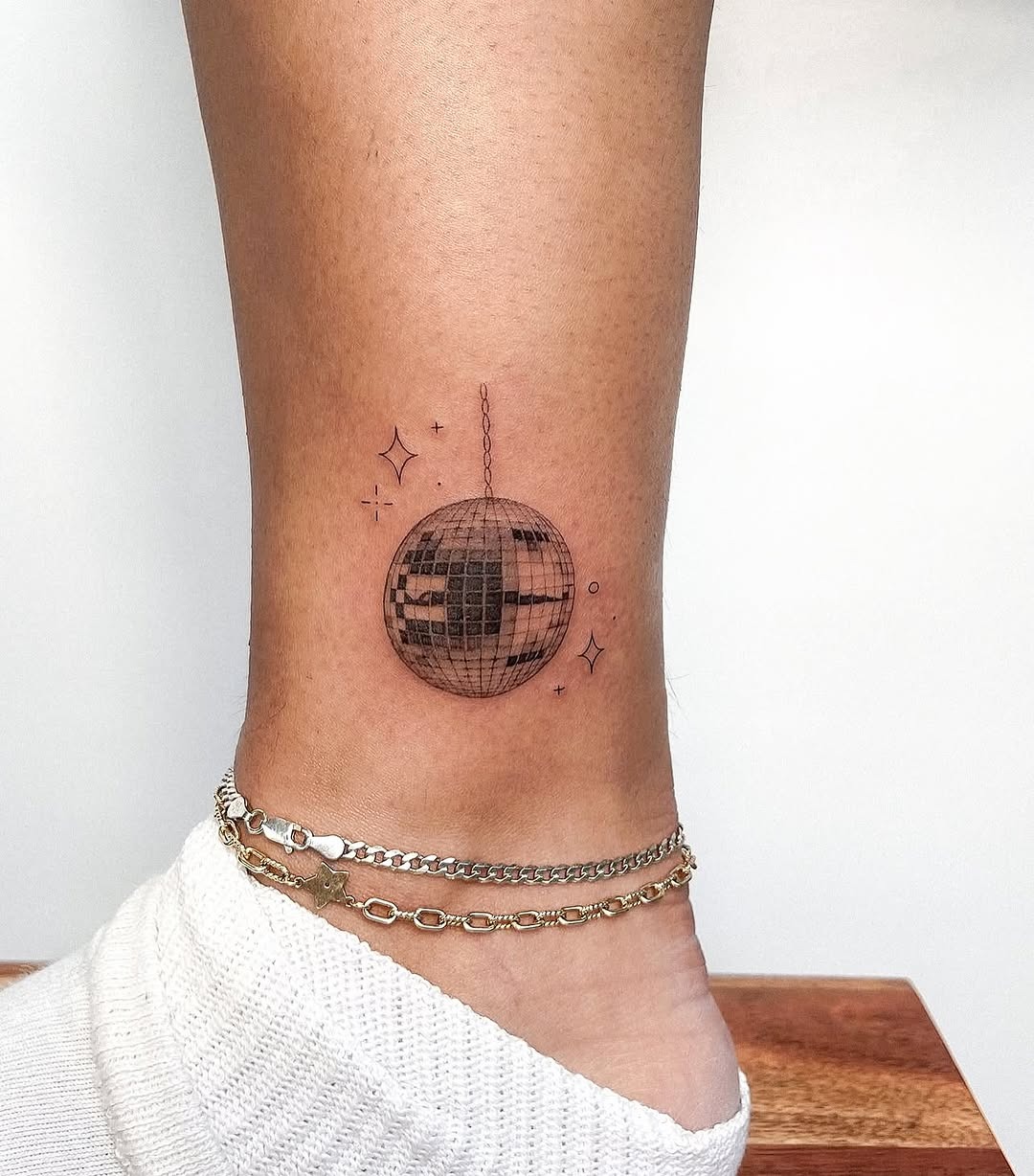 Charming minimalist disco ball ankle tattoo design Tattoo Design