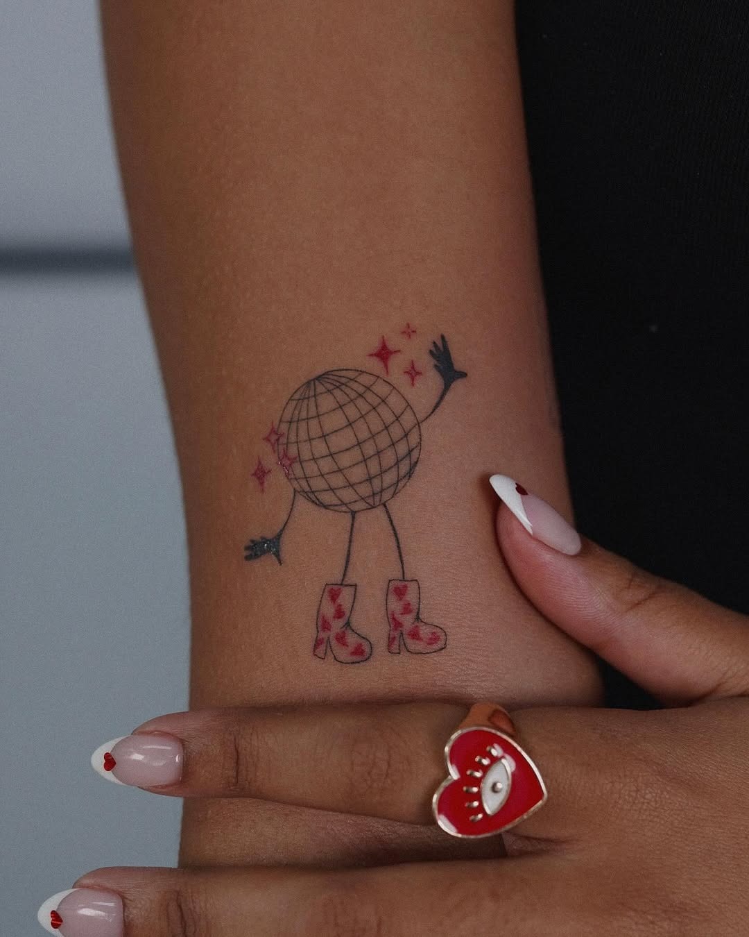 Chic disco ball tattoo with stylish boots Tattoo Design