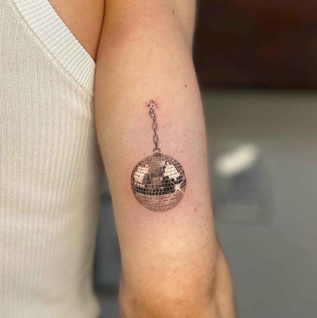 Elegant disco ball tattoo on a trendy arm Tattoo Design
