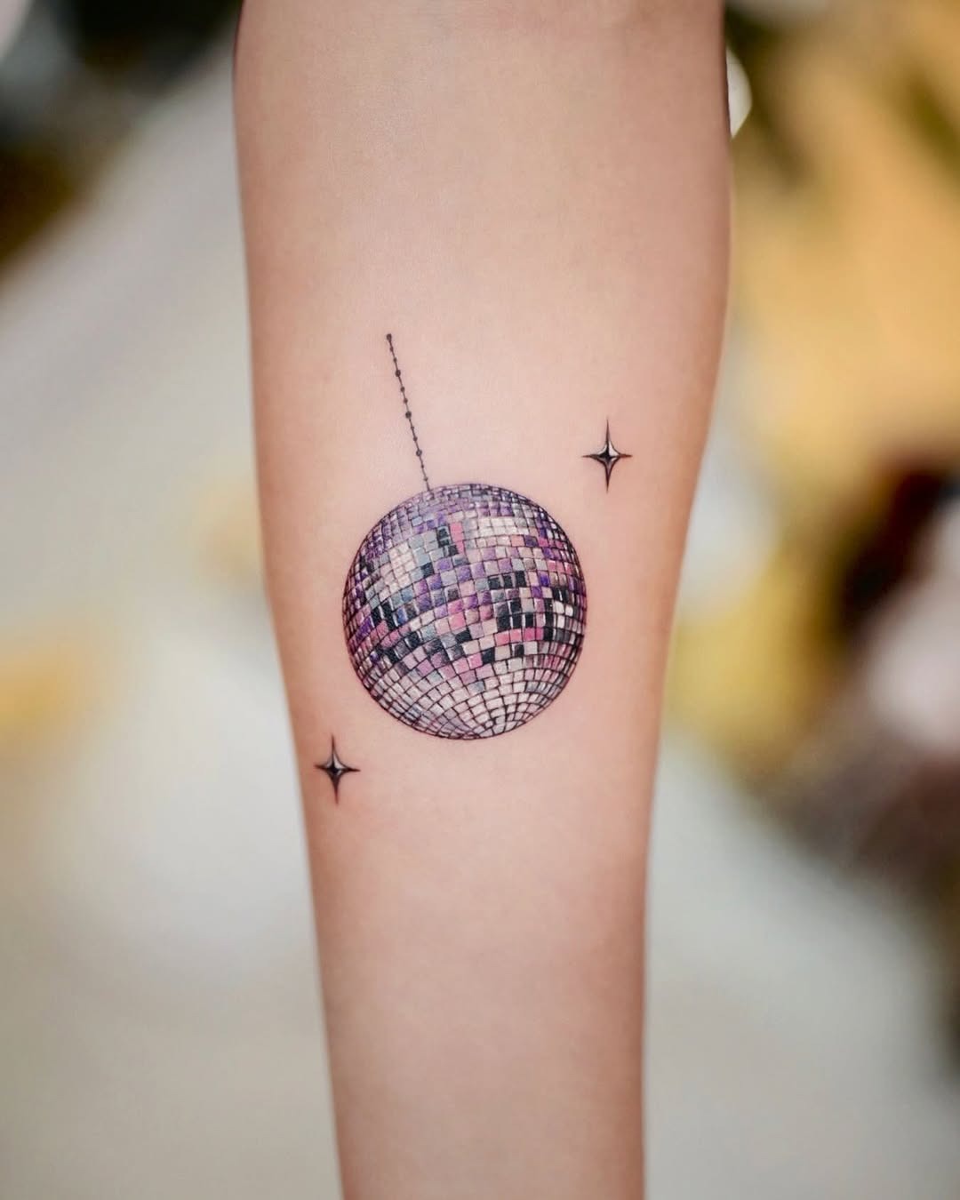 Glamorous disco ball tattoo with shining stars Tattoo Design