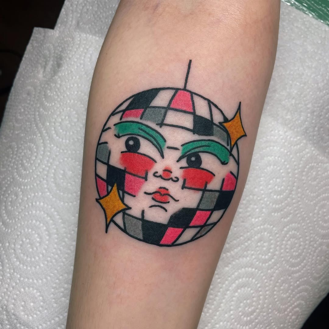 Stylish disco ball tattoo with unique face design Tattoo Design
