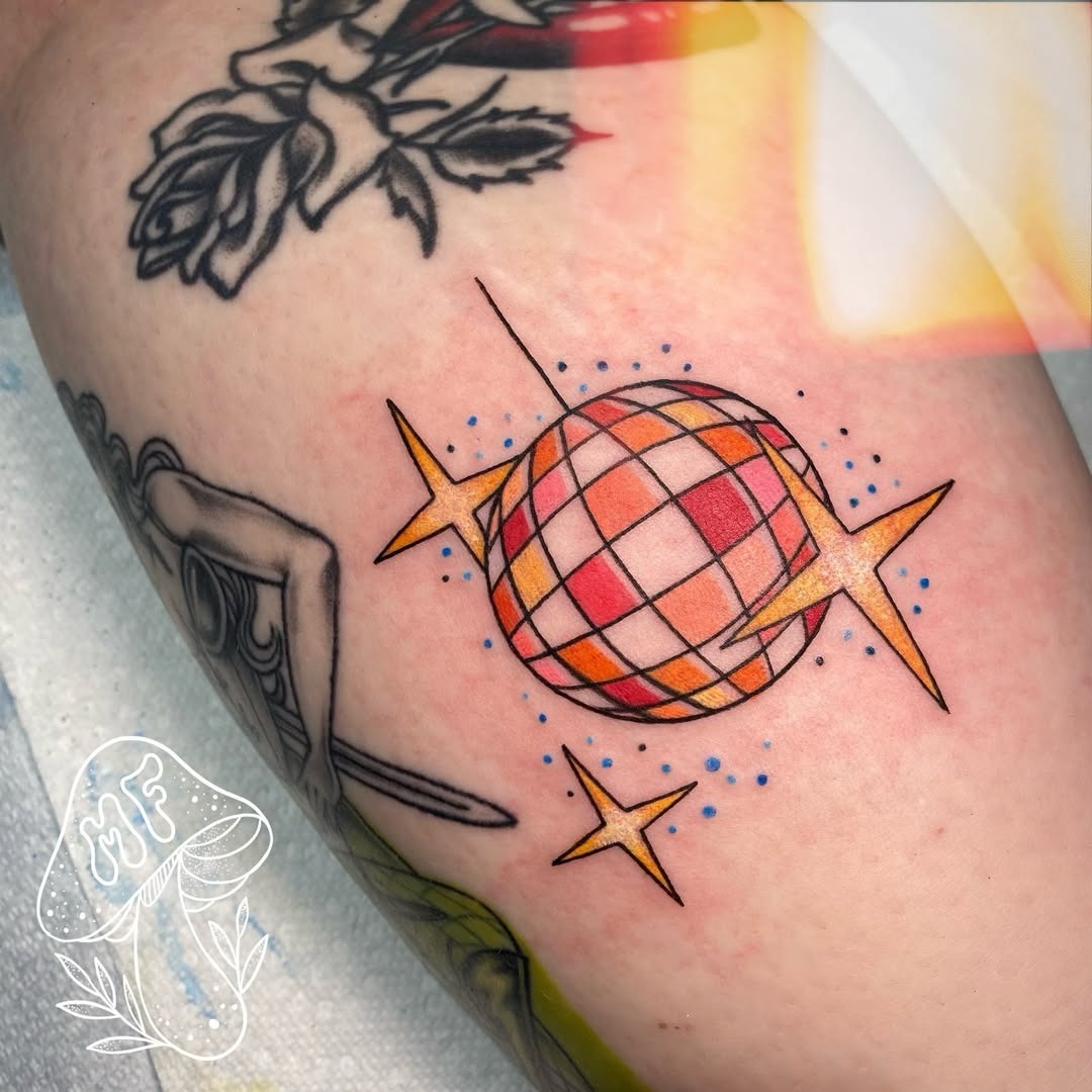 Vibrant disco ball tattoo with playful stars Tattoo Design