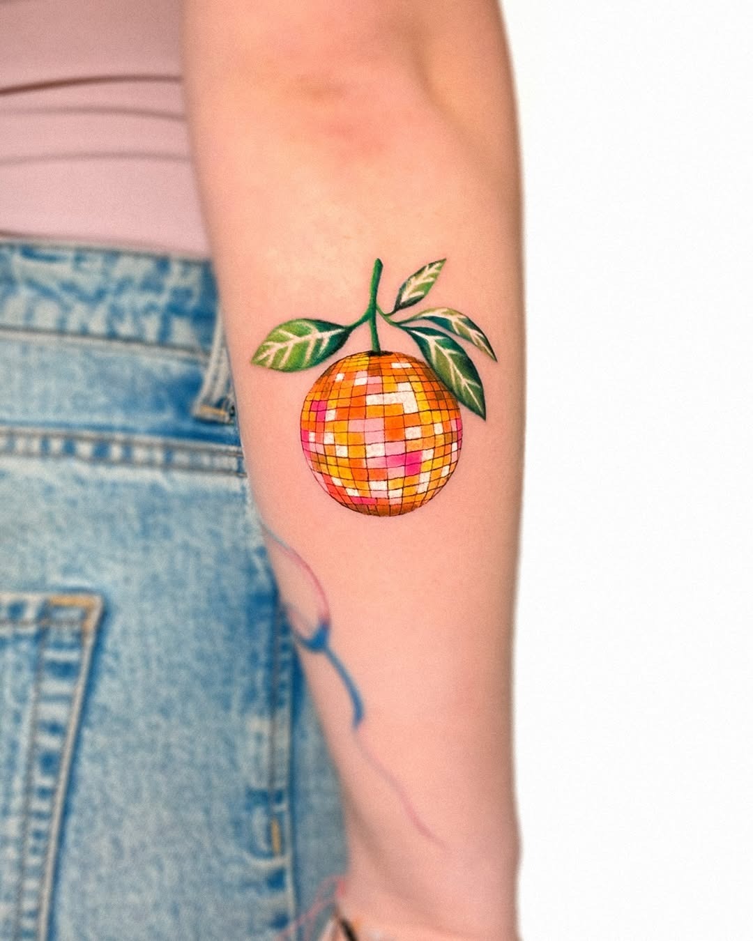 Vibrant orange disco ball tattoo with leaves Tattoo Design
