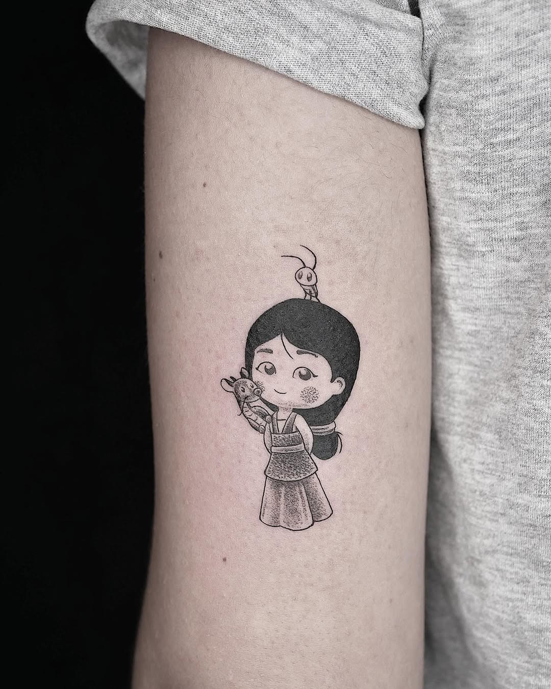 This tattoo beautifully portrays Mulan, showing her iconic style alongside her loyal friends.