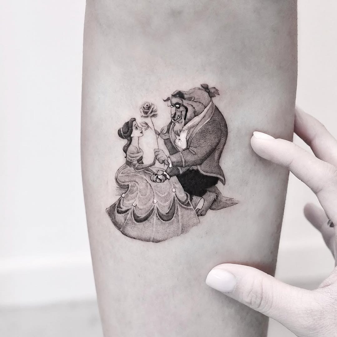 This tattoo captures the iconic moment from 'Beauty and the Beast,' where Belle and the Beast share a romantic connection.