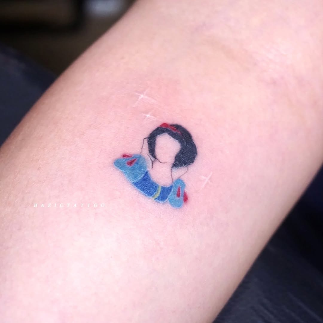 This adorable Snow White tattoo captures the timeless charm of the beloved princess.