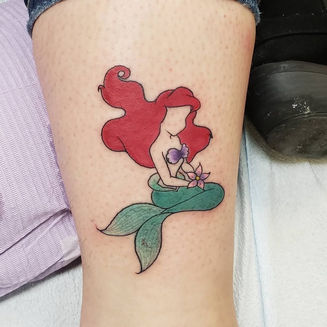 This tattoo features Ariel, a beloved Disney princess.