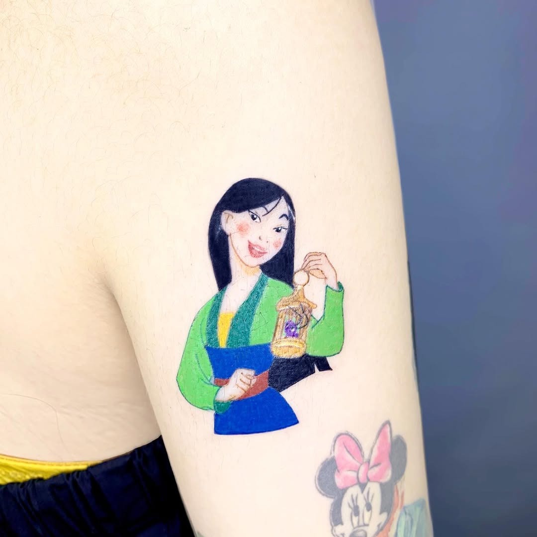 This tattoo features Mulan showing her bravery.