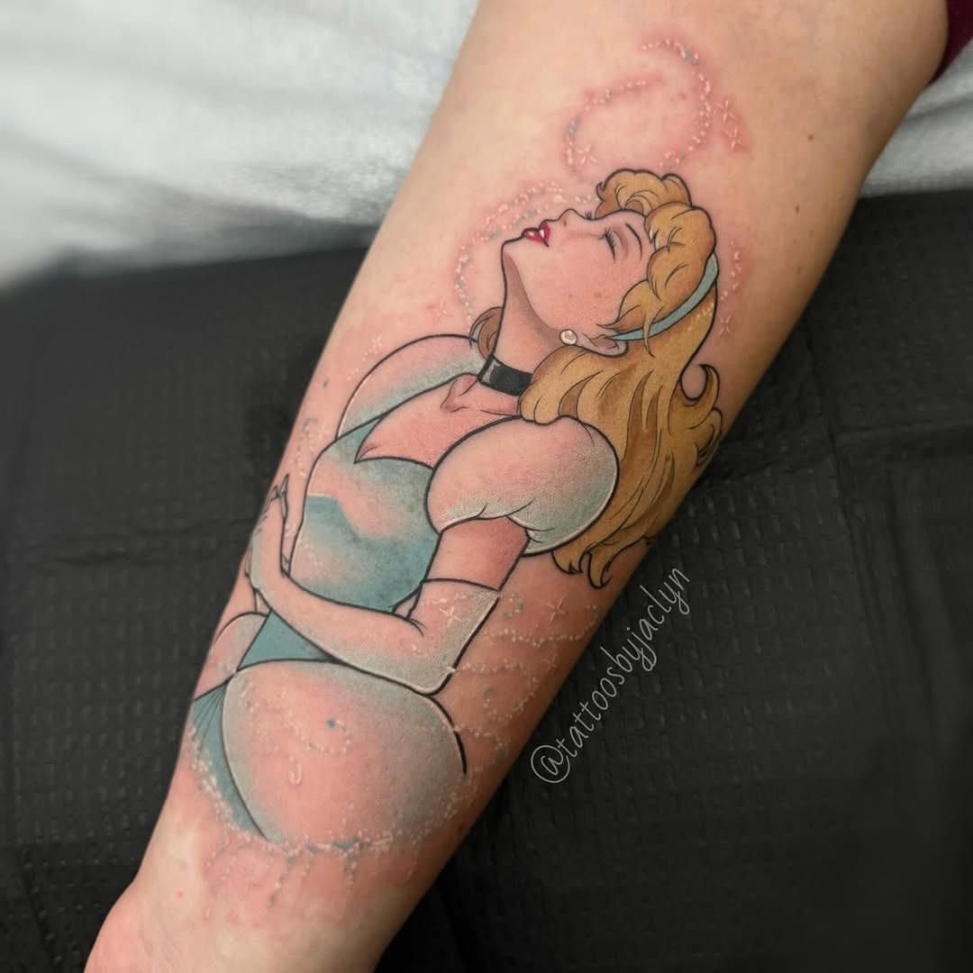 This beautiful tattoo features Cinderella in a serene pose, her dreamy expression captured perfectly.