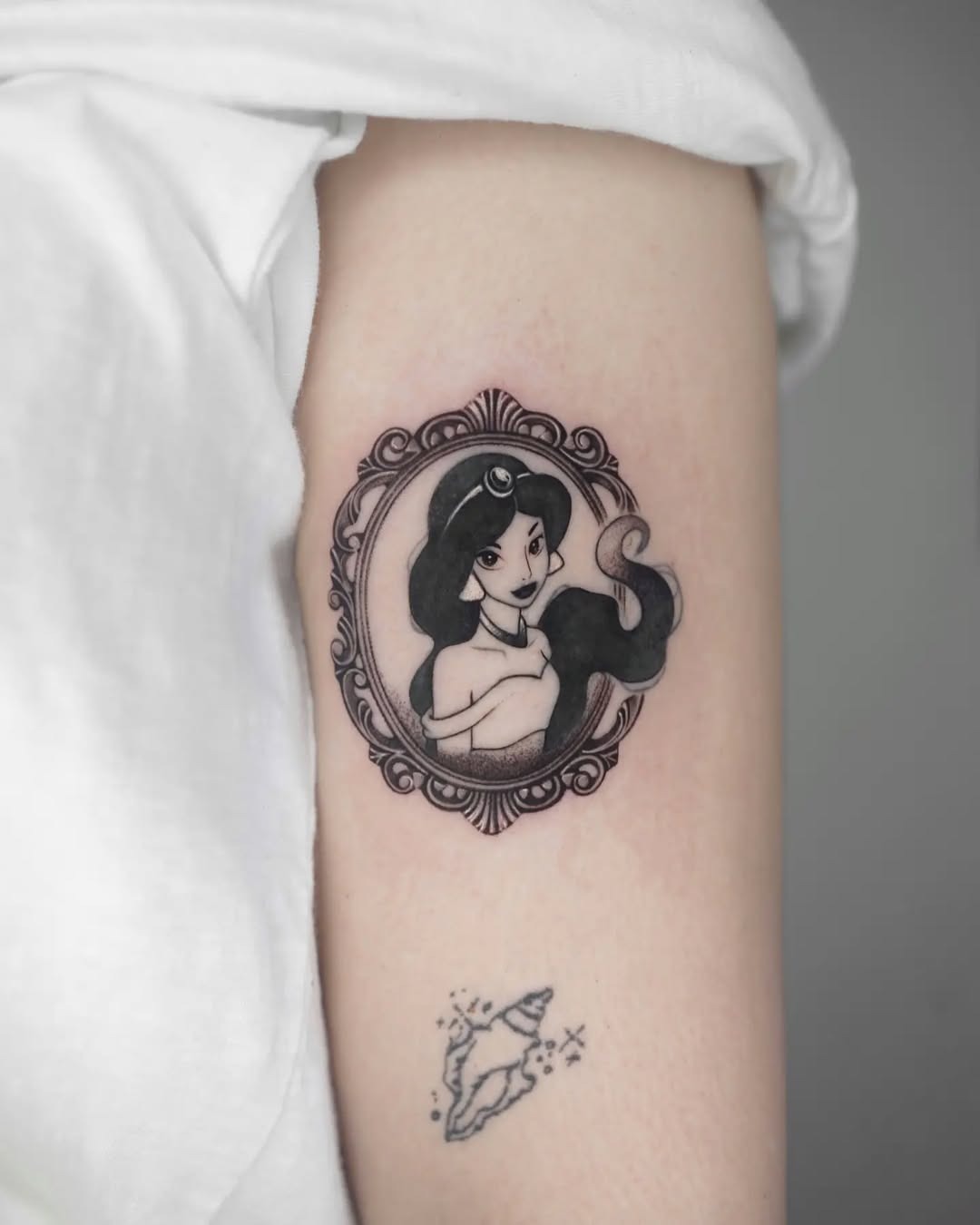 This tattoo features Jasmine in a beautifully detailed black and white design.