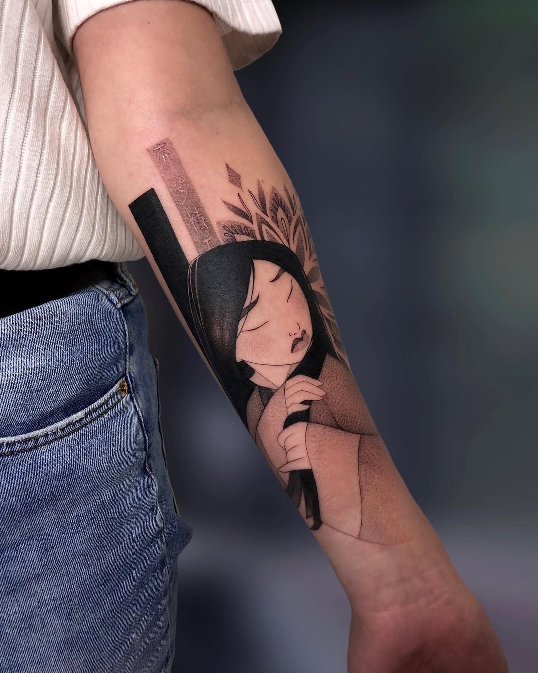 This stunning tattoo features Mulan in a serene pose, flawlessly blending her figure with intricate designs inspired by nature.