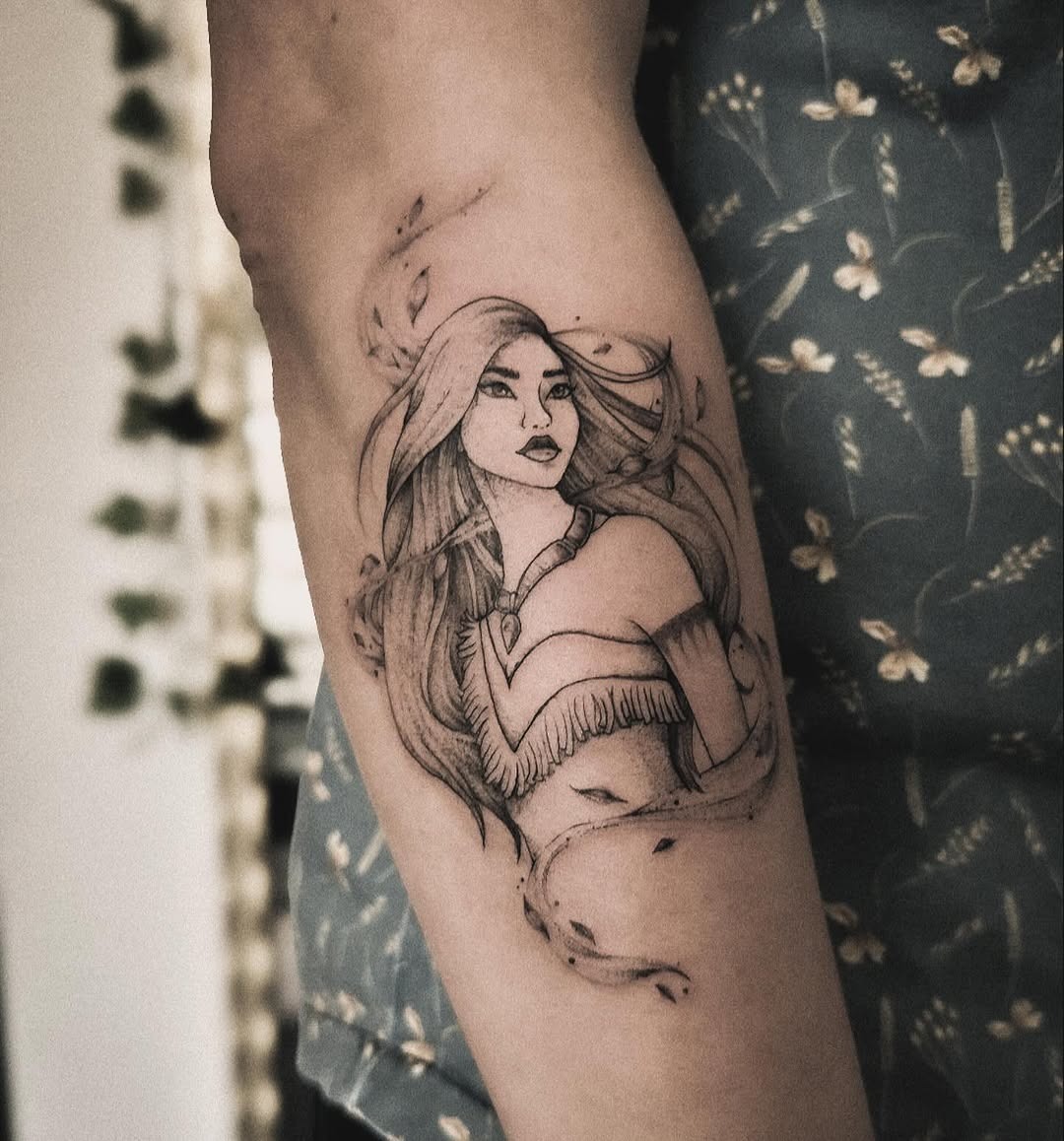 This tattoo beautifully captures Pocahontas's essence with intricate line work and flowing hair.