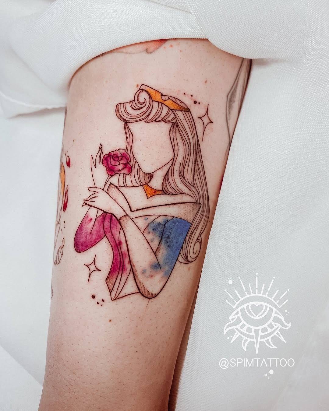 This tattoo showcases a stunning depiction of a Disney princess holding a rose.