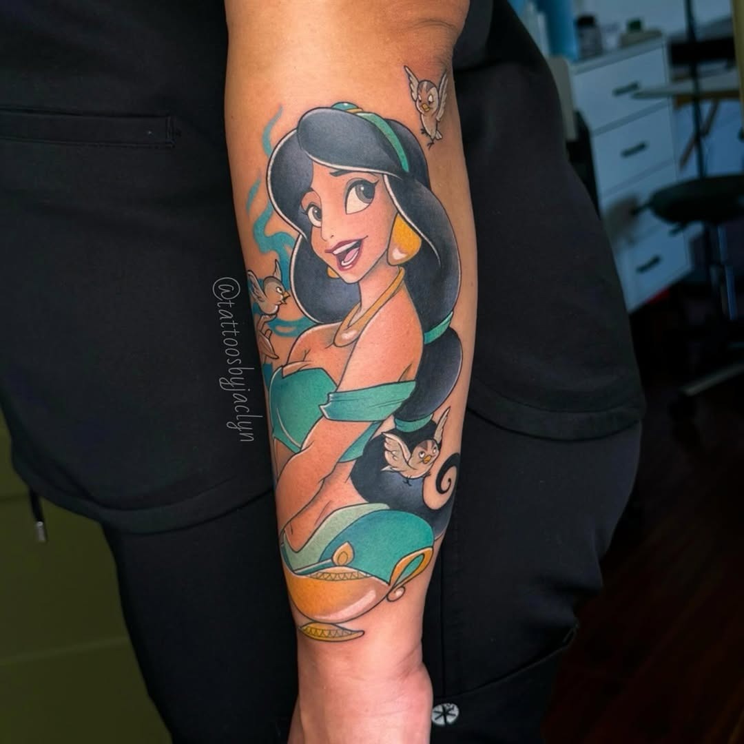 This tattoo features Princess Jasmine from Disney's Aladdin, elegantly posed with her mischievous animal friends.