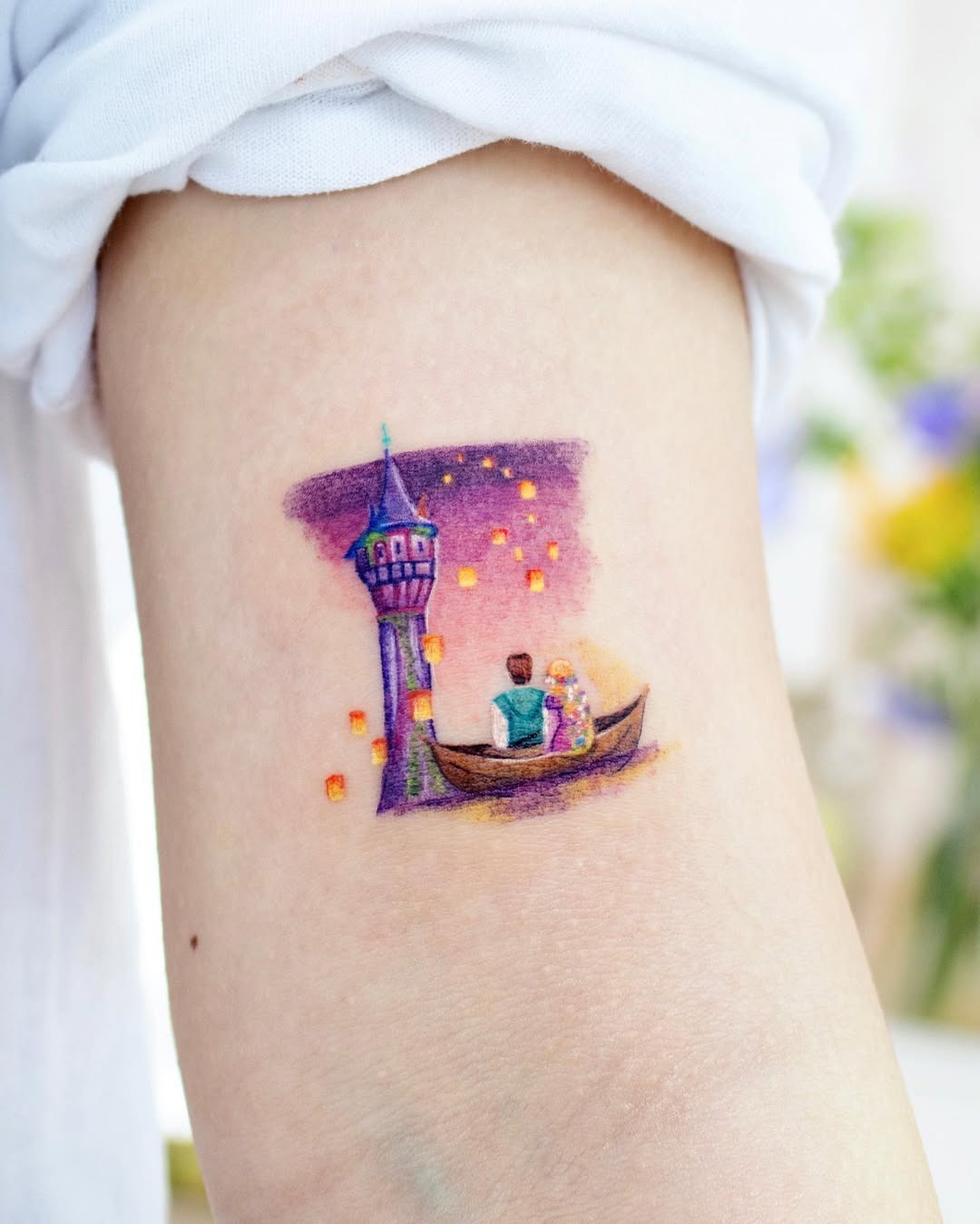 This enchanting tattoo captures Rapunzel and Flynn in a boat under a sky filled with floating lanterns.