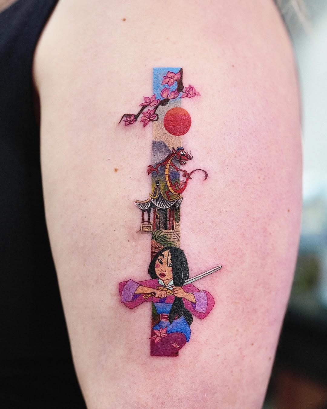 This tattoo features Mulan in a dynamic pose, showing her strength and courage.