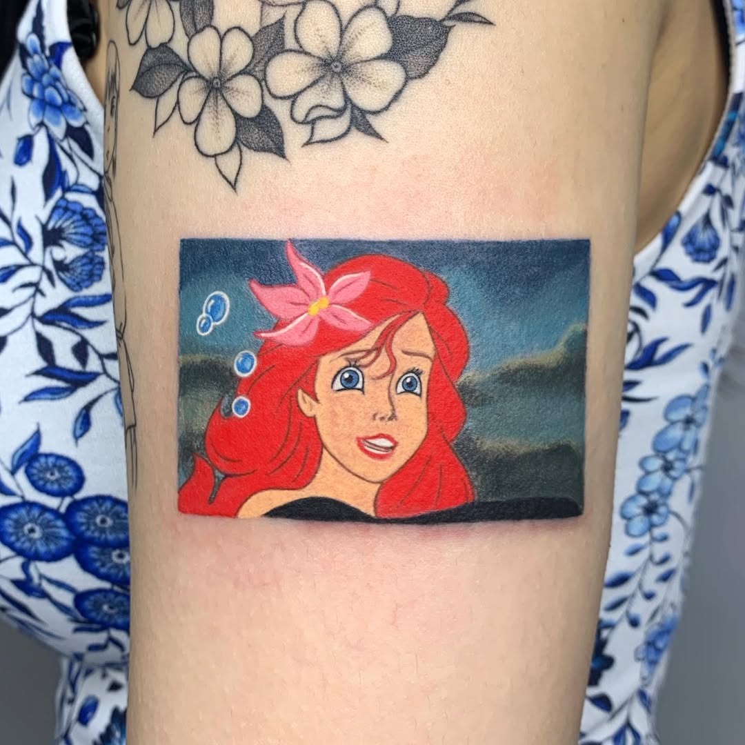 This tattoo features Ariel, the beloved Disney Princess, captured in colors.