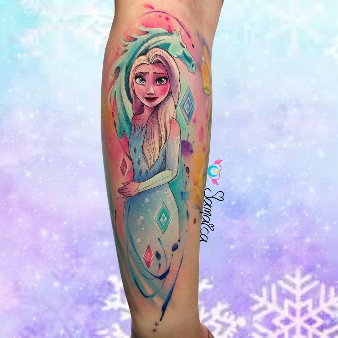 This stunning tattoo features Elsa from Disney's Frozen, depicted with a whimsical watercolor style.