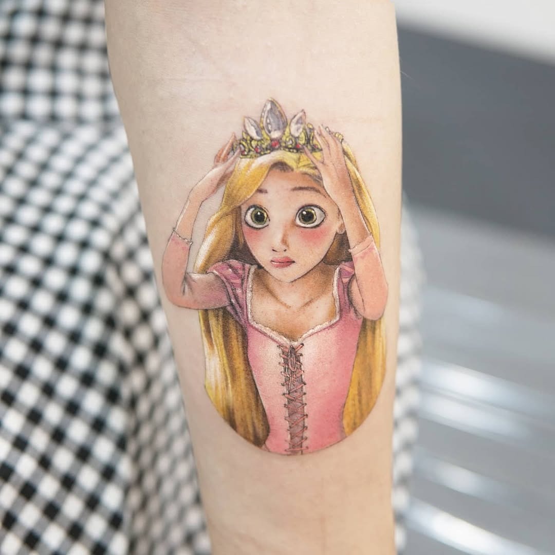 This stunning tattoo features Rapunzel in intricate detail, showing her iconic long hair and a sparkling crown.