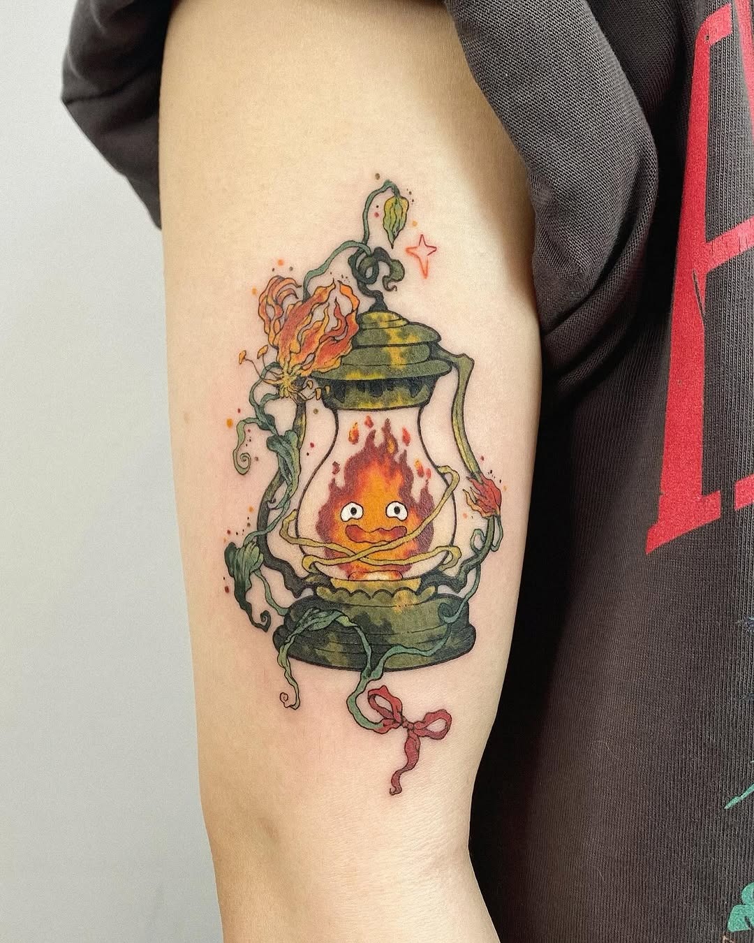 This tattoo displays a whimsical lantern with a playful flame inside, evoking feelings of warmth and nostalgia.