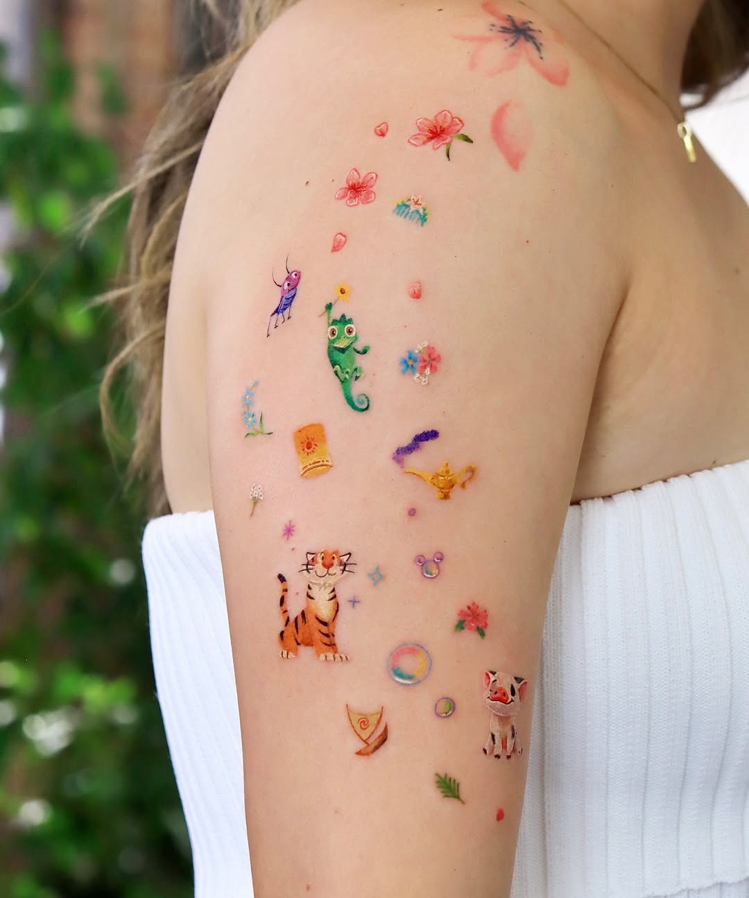 This arm features a whimsical collection of Disney-themed tattoos, from adorable characters to enchanting symbols.