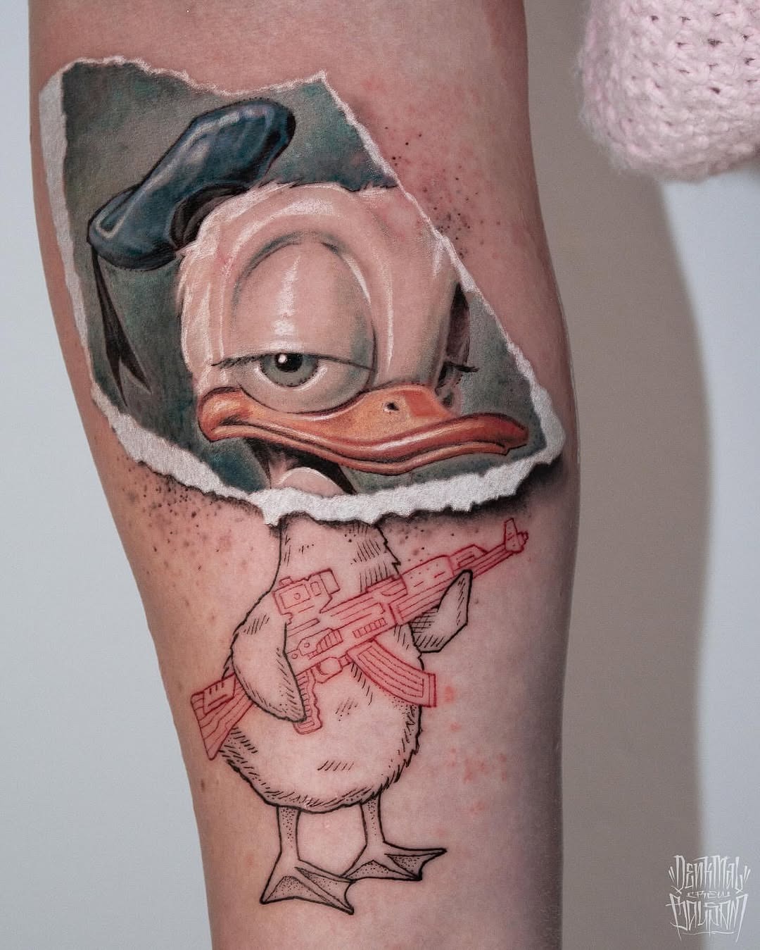 This tattoo showcases Donald Duck, playfully depicted with a twist.