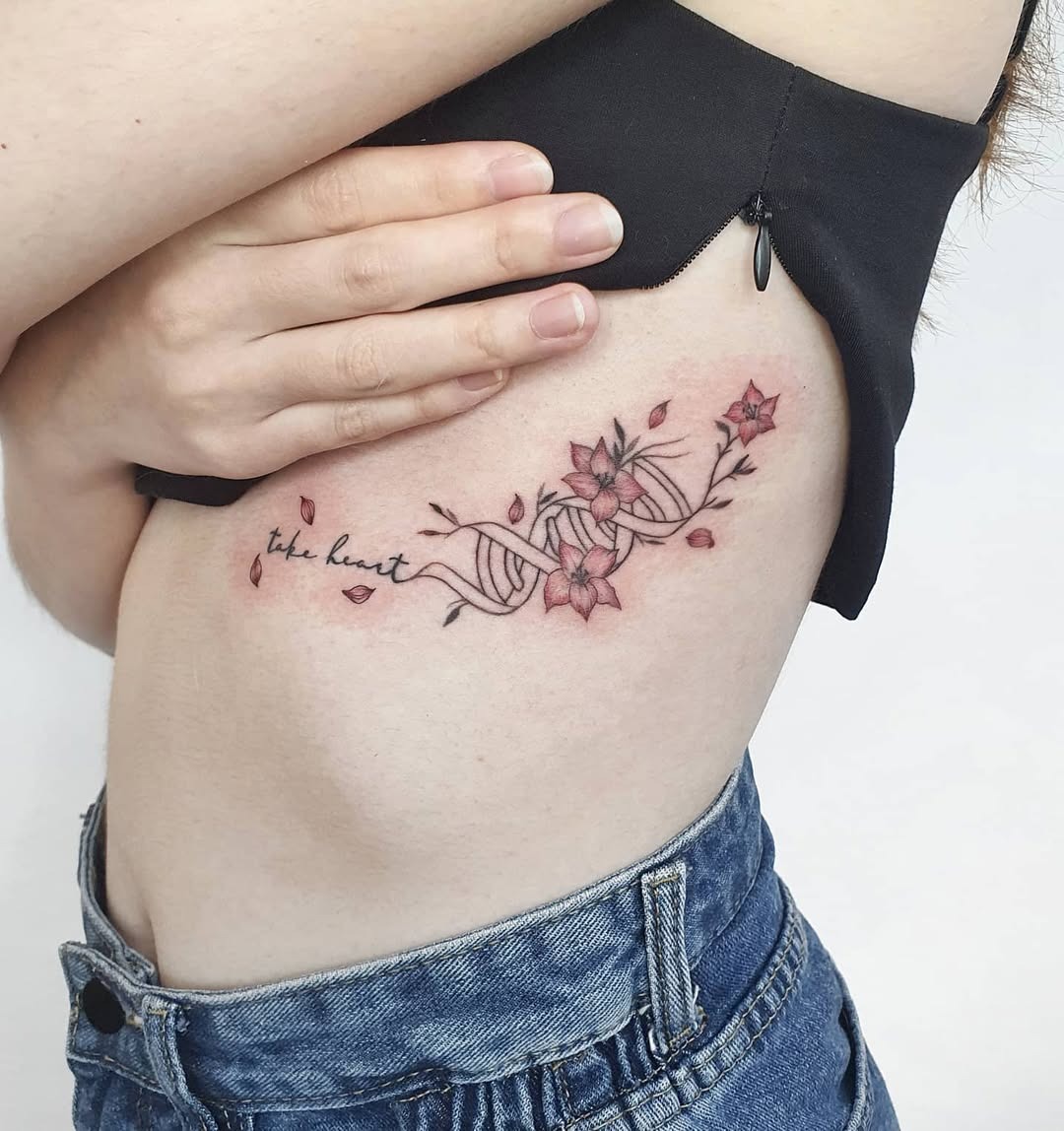 This DNA tattoo combines delicate lines with blossoming flowers, showing a unique blend of science and nature.