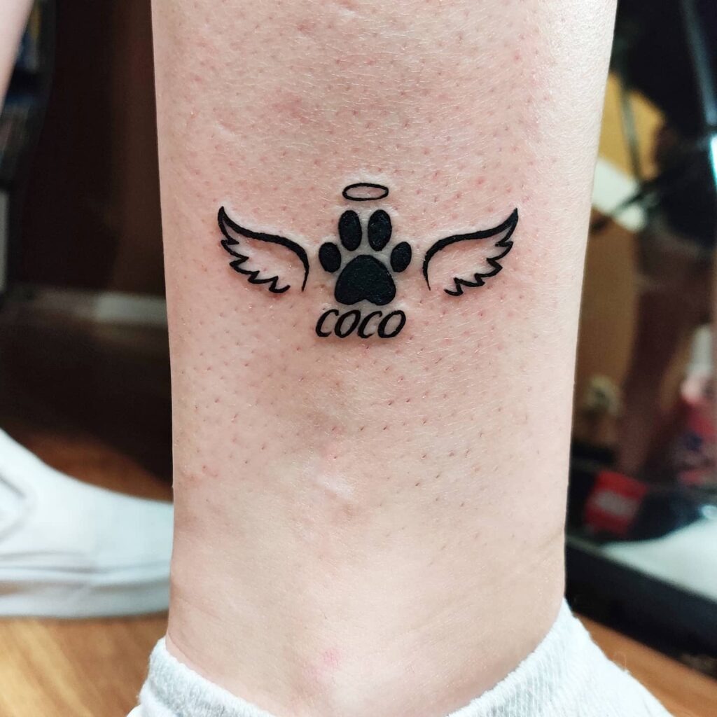 Playful Cartoon Dog with Paw Print Tattoo Tattoo Design