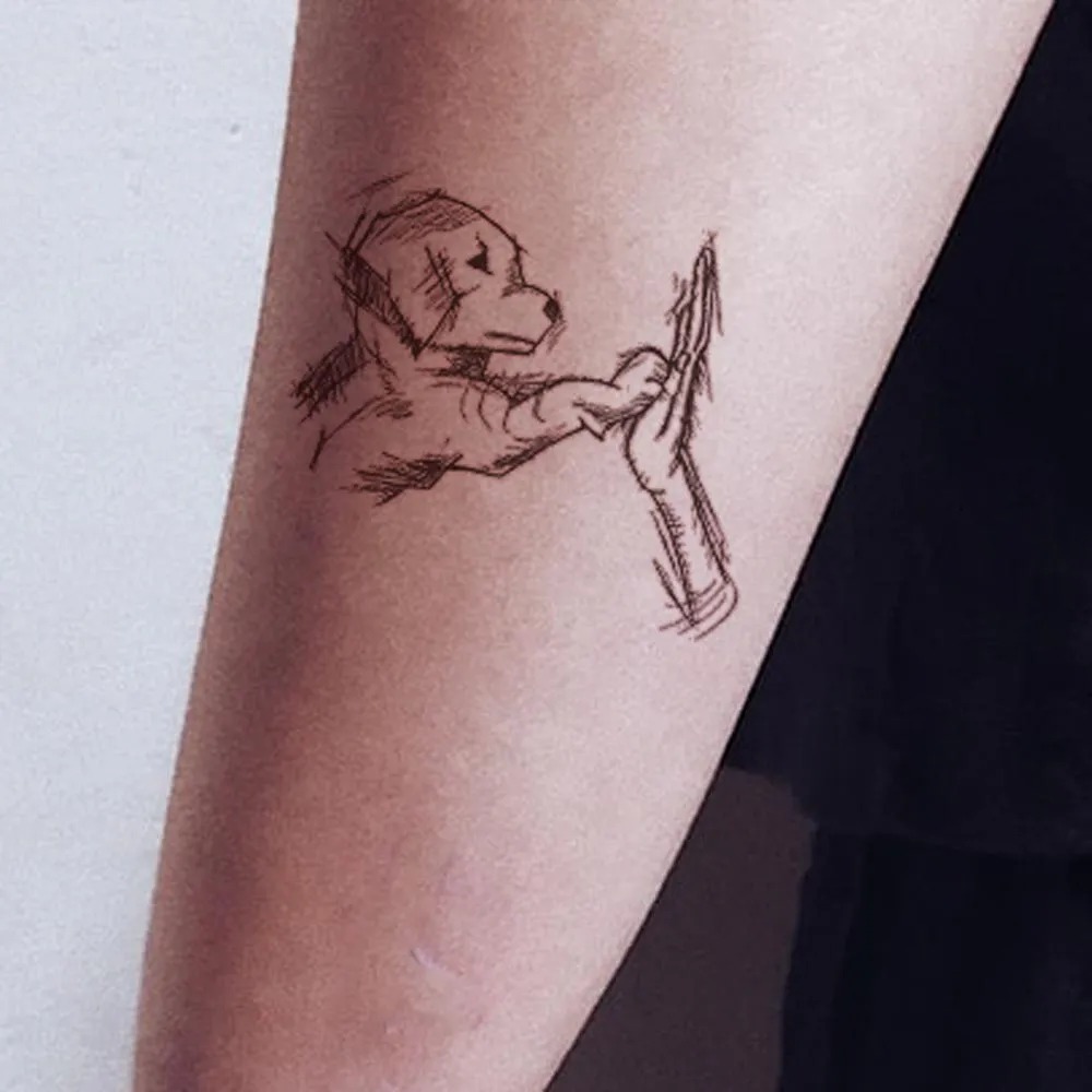 Sketch-Style Dog and Hand Tattoo Design